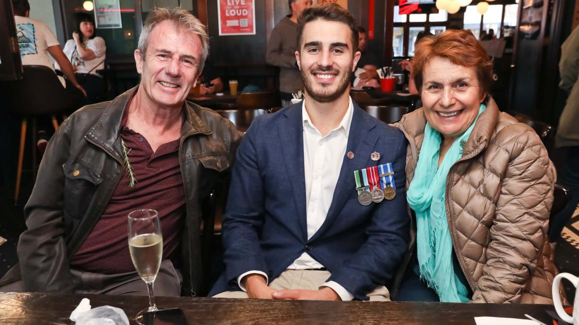 Anzac Day at the Regent, a serviceman seated with his parents.